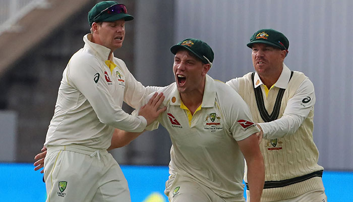 Australia´s Cameron Green (C) celebrates with Australia´s Steve Smith (L) and Australia´s David Warner (R) after taking a catch to dismiss England´s Ben Duckett off the bowling of Australia´s Pat Cummins on day three of the first Ashes cricket Test match between England and Australia at Edgbaston in Birmingham, central England on June 18, 2023.—AFP