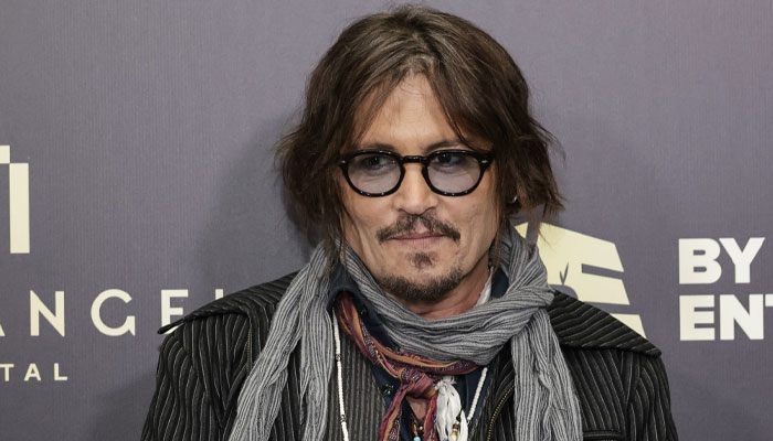 Johnny Depp returns to stage wearing an ankle brace following recent injury