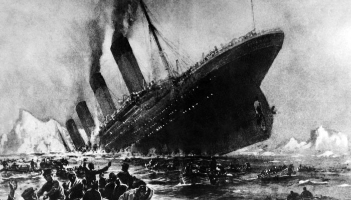 This artistic impression shows the sinking Titanic ship with people in the Atlantic Ocean. — AFP/File