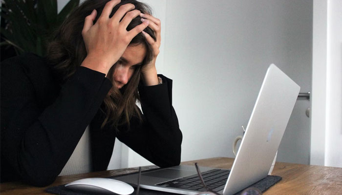 A representational image of a woman sitting anxious and stressed. — Unsplash/File