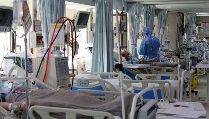 A healthcare professional can be seen treating a patient in Iran. — Reuters/File