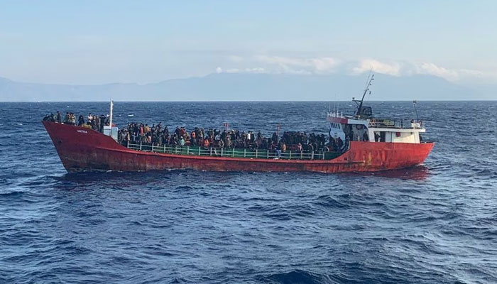 A cargo ship carries migrants during a rescue operation, as it sails off the island of Crete, Greece, October 29, 2021. — Reuters