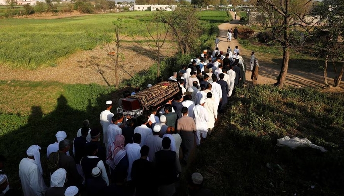 People carry the coffin of Muhammad Ali, 21, who along with others died when a migrant boat shipwrecked off the coast near Benghazi in Libya, during his funeral at a graveyard in Bhojpur town in Gujrat district of Punjab province, Pakistan March 7, 2023.