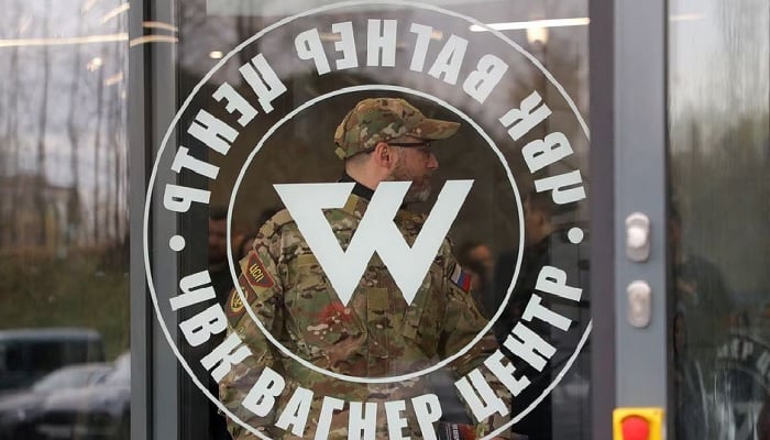 A man wearing a camouflage uniform walks out of PMC Wagner Centre, which is a project implemented by the businessman and founder of the Wagner private military group Yevgeny Prigozhin, during the official opening of the office block in Saint Petersburg, Russia, November 4, 2022. — Reuters/File