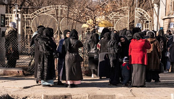 Afghan female university students are stopped by Taliban security personnel near a university in Kabul on December 21, 2022. —AFP