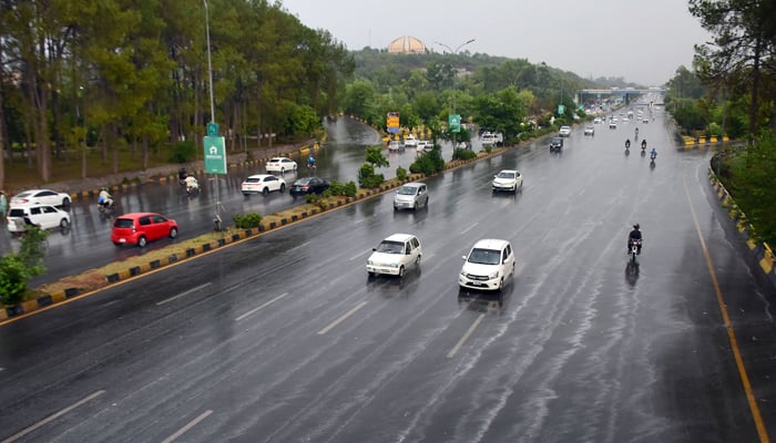 Vehicles seen driving through the roads of Islamabad as the city received heavy pre-monsoon rains on June 24, 2023. — Online