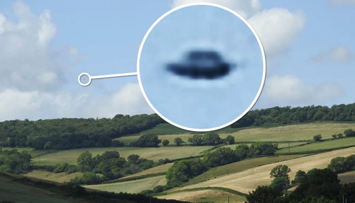 This image captured by ufologist John Mooner shows a black flying object which he claims is a UFO over the English countryside in Devon. — John Mooner/Pen News via The New York Post