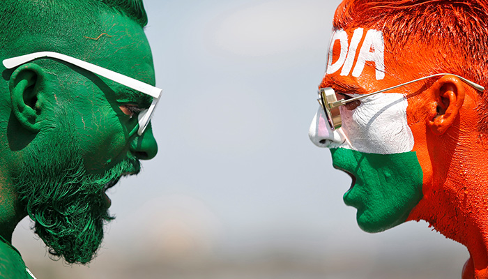 Cricket fans, with their faces painted in the Indian and Pakistani national flag colours, pose for a picture ahead of the first match between India and Pakistan in T20 World Cup super 12 stage in Dubai, in Ahmedabad, India, October 23, 2021. — Reuters