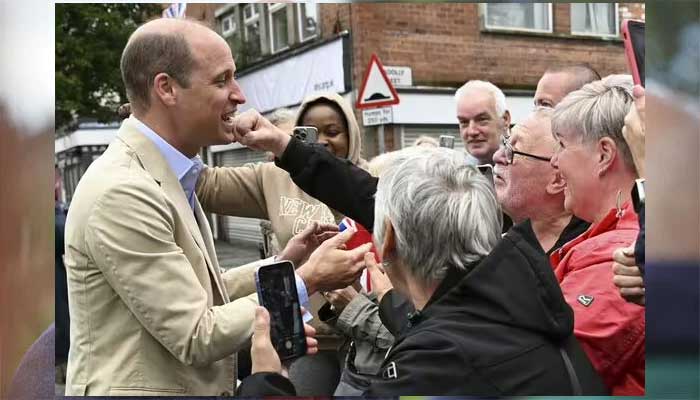 Prince William smiles as man tries to punch him