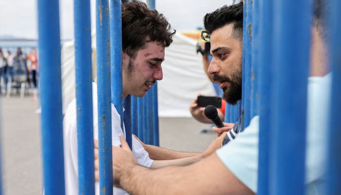 Mohamed, 18, who was rescued, cries as he reunites with his brother Fadi. — Reuters/File