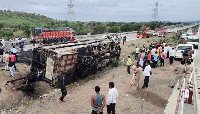 This image shows a charred bus tipped over on the side of the expressway where it caught fire killing 25 people. — AFP/File