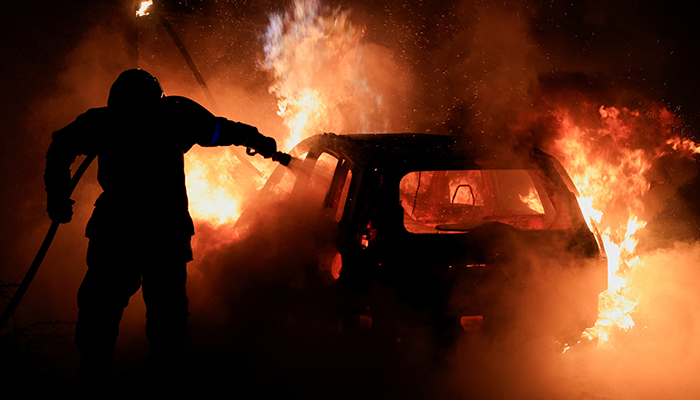 A French firefighter works to extinguish a burning car during the fifth day of protests following the death of Nahel, a 17-year-old teenager killed by a French police officer in Nanterre during a traffic stop, in Tourcoing, France, July 2, 2023. — Reuters