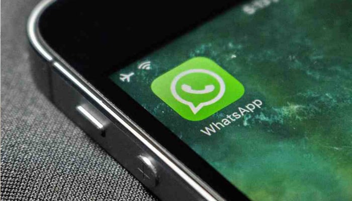 WhatsApp logo can be seen in the corner of an iPhones screen. — Reuters