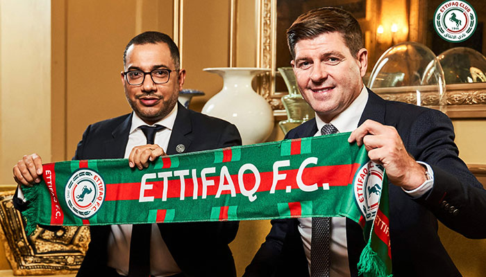 This handout picture released by Saudi Arabia´s al-Ettifaq football club on July 3, 2023 shows Ettifaq´s new English manager Steven Gerrard (R) with the club´s President Khaled al-Debel after signing with them in London.—AFP