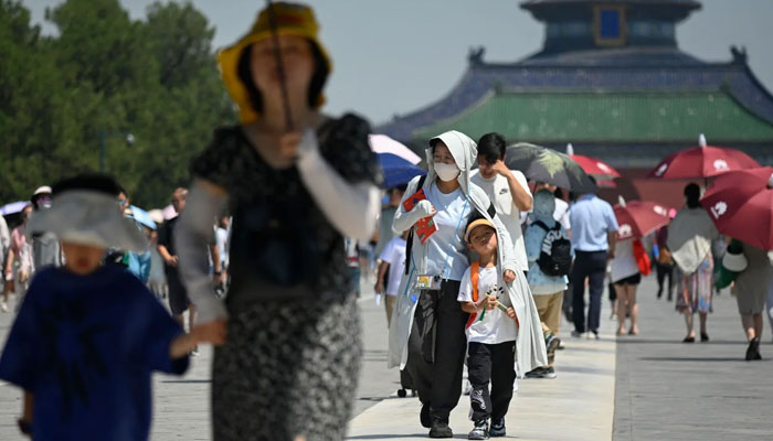 Tourists visit the Temple of Heaven on a hot day in Beijing on June 30, 2023. AFP/File