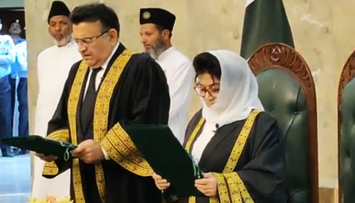 Chief Justice Umar Ata Bandial (left) administers the oath to Justice Mussarat Hilali, making her the second woman SC judge, in Islamabad, on July 7, 2023, in this still taken from a video. — Reporter