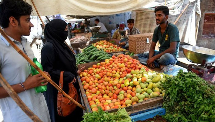 A  man is selling vegetables in a local market. — AFP