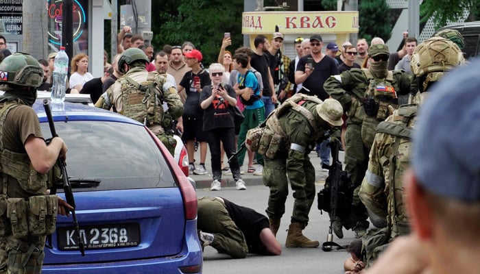 Members of the Wagner group detain a man in the city of Rostov-on-Don, on June 24, 2023. — AFP