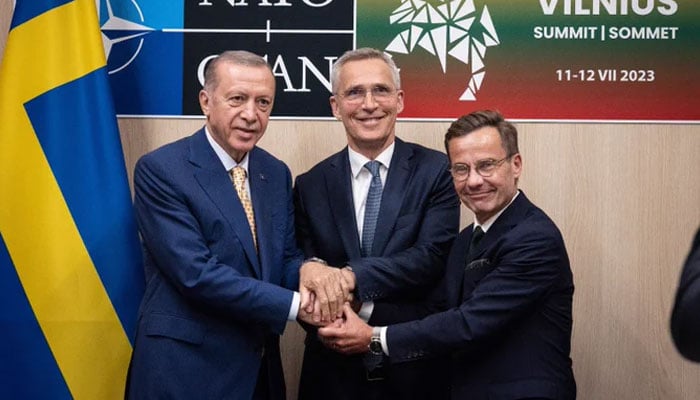 Turkish President Tayyip Erdogan (L) and Swedish Prime Minister Ulf Kristersson shake hands next to NATO Secretary-General Jens Stoltenberg prior to their meeting, on the eve of a NATO summit, in Vilnius on July 10, 2023. Twitter/jensstoltenberg