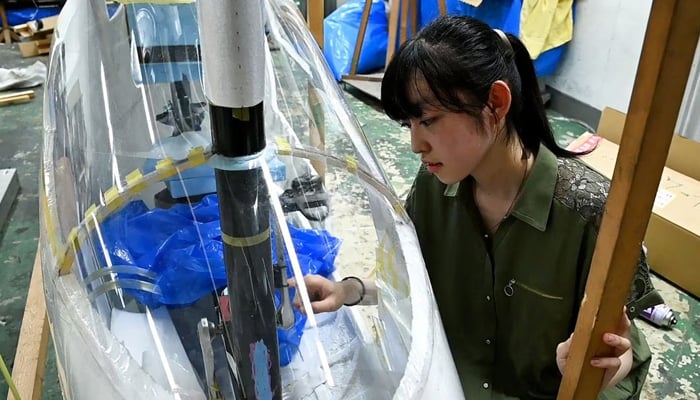 Yuna Kato works with her college club to produce a light human-powered aircraft at Tokyo University in Tokyo, June 30, 2023, in this screen grab from video. — Reuters