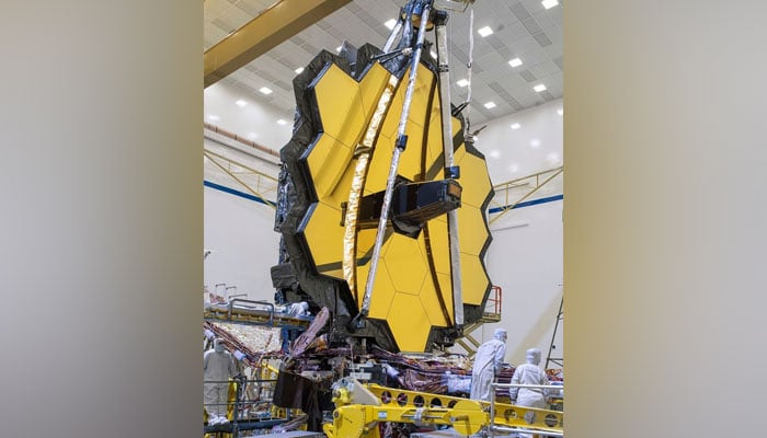 The James Webb Space Telescope stands tall in the Northrop Grumman clean room. Light reflects off of its giant, hexagonal primary mirror, the focal point of the image on January 27, 2023. — Twitter/NasaWebb