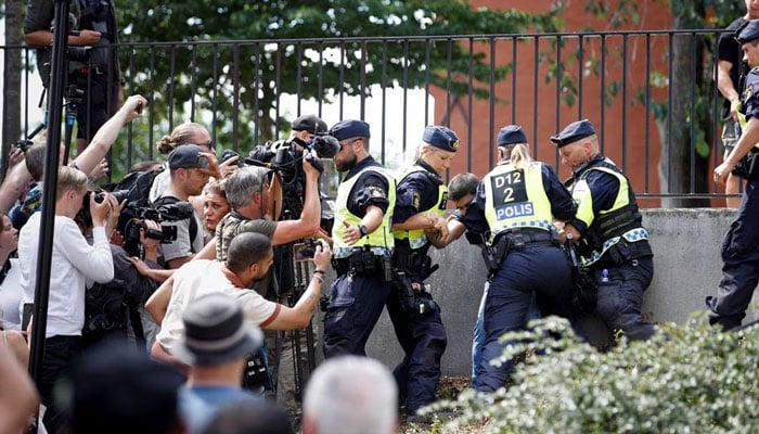 Police officers intervene after peoples reaction as demonstrators burn the Quran (not pictured) outside Stockholms central mosque in Stockholm, Sweden June 28, 2023. — Reuters/File