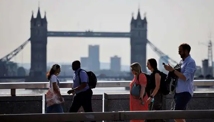 Office workers cross London Bridge in this undated image. — AFP/File