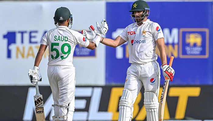 Pakistan´s Agha Salman (right) celebrates with Saud Shakeel after scoring a half-century during the second day of the first cricket Test match between Sri Lanka and Pakistan at the Galle International Cricket Stadium in Galle on July 17, 2023. — AFP