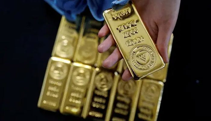 An employee works on 1kg. gold bars in Ahlatci Metal Refinery in the central Anatolian city of Corum, Turkey, May 11, 2017. — Reuters