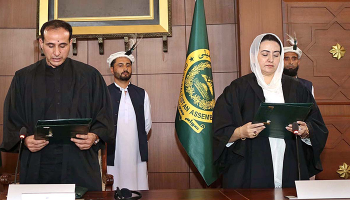 Speaker Gilgit-Baltistan Assembly Advocate Nazir Ahmad (left) administering oath from the newly-elected Deputy Speaker Gilgit-Baltistan Assembly Sadia Danish at Assembly Secretariat on July 17, 2023. — APP