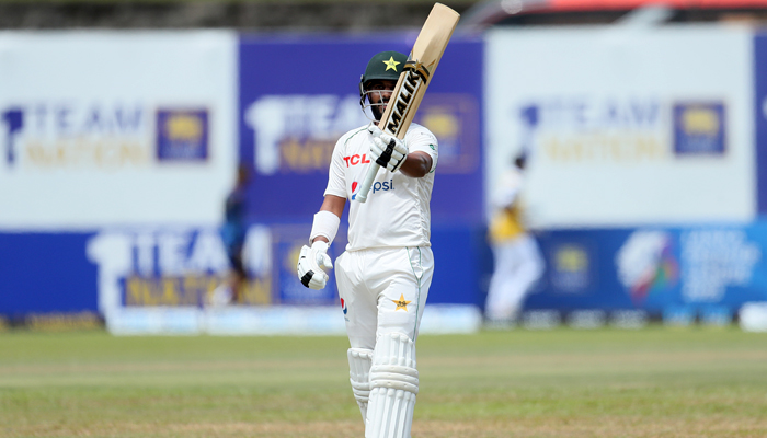 Pakistan batter Saud Shakeel raises bat after scoring century in the first Test against Sri Lanka on Tuesday. —SLC