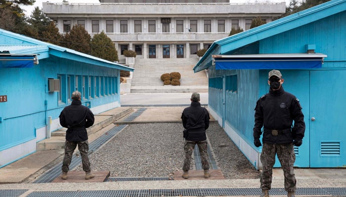 South Korean soldiers stand guard during a media tour of the Joint Security Area (JSA) in the Demilitarized Zone (DMZ) in the border village of Panmunjom in Paju on 03 March 2023. — AFP