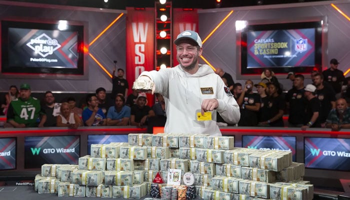 Daniel Weinman displays his championship bracelet and bundles of cash after winning the World Series of Poker Main Event.—AP