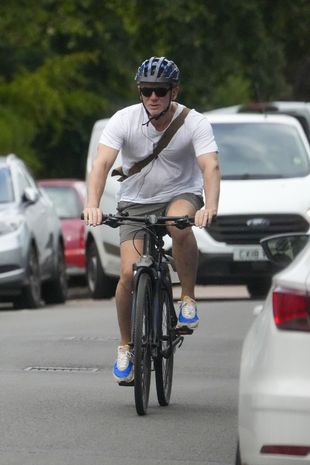 Daniel Craig riding bicycle ( Image: SplashNews.com)