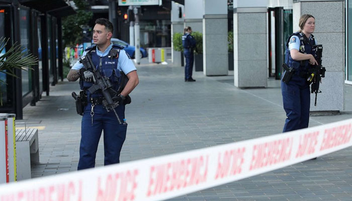Police officers stand guard near the location of a reported shooting in Auckland, New Zealand, July 20, 2023.Reuters