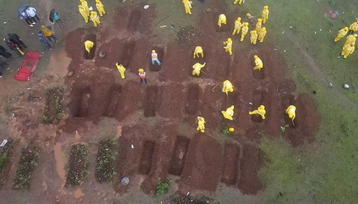 A drone view shows members of rescue teams preparing graves to bury the victims after a landslide following heavy rains in Raigad district in the western state of Maharashtra, India, July 20, 2023. — Reuters