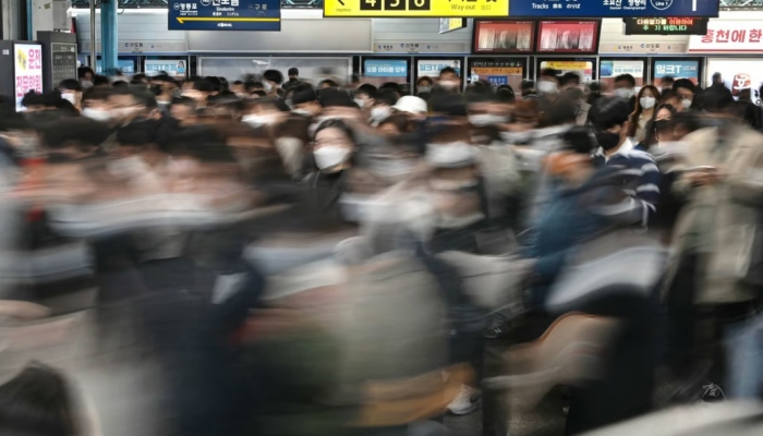 An image of commuters walking through a subway station in Seoul — AFP/Files