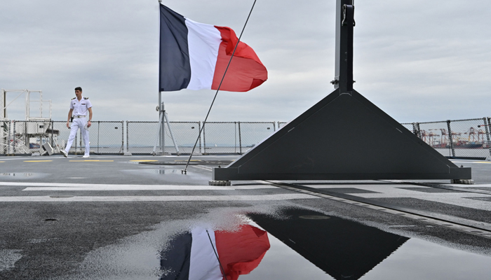 The French flag flutters in the wind during a media tour of the French frigate Lorraine on its visit to the port in Tokyo on May 31, 2023. — AFP