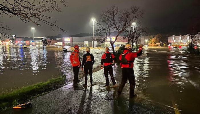 Rescue workers helping people who are trapped on the other side of Bedford Highway and into the Bedford Place Mall on July 22, 2023. — Twitter/@HalifaxSAR