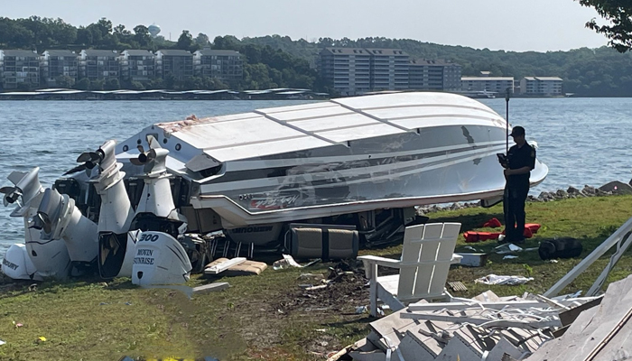 A boat can be seen overturned after it was smashed into a house on the shore of the Lake of the Ozarks on July 22, 2023. — Twitter/@MSHPTrooperF