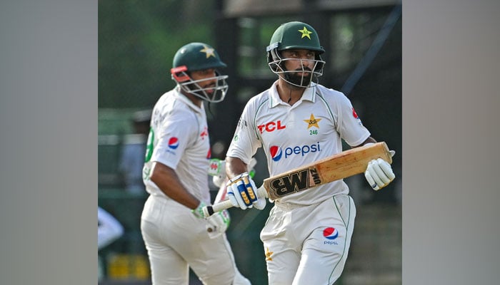 Pakistans Abdullah Shafique (right) and Shan Masood run between wickets during the first day of the second and final cricket Test match between Pakistan and Sri Lanka at the Sinhalese Sports Club (SSC) ground in Colombo on July 24, 2023. — AFP