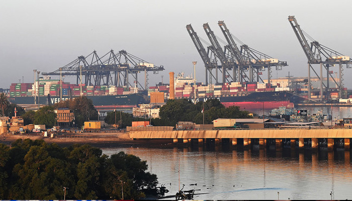 Shipping containers are seen stacked on a ship at a sea port in Karachi on April 6, 2023. — AFP