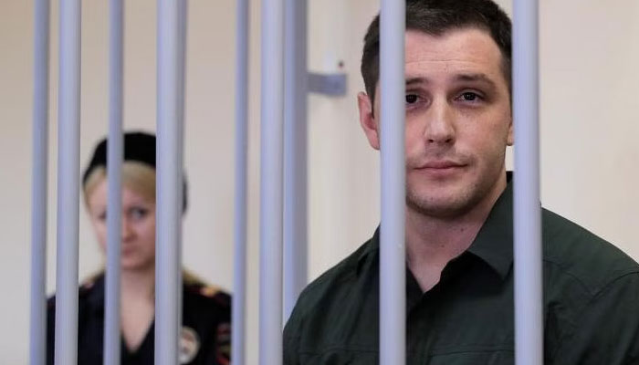 A 2019 photo shows Trevor Reed in Russian detention, accused of assaulting police officers. REUTERS/File