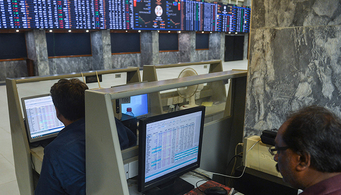 Brokers monitor the latest share prices at the Pakistan Stock Exchange in Karachi on February 14, 2023. — AFP