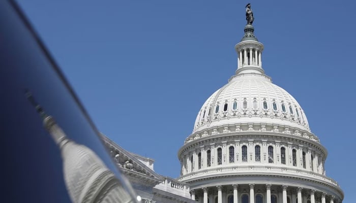 The dome of the US Capitol is reflected in a window on Capitol Hill in Washington, US April 20, 2023. — Reuters