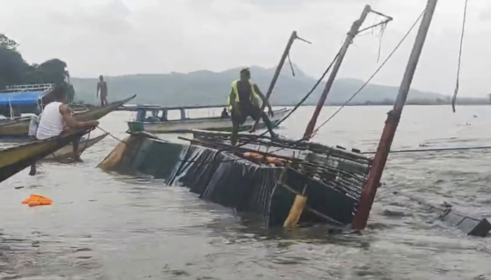 A man stands on the capsized passenger boat in Binangonan, Rizal province, Philippines, July 27, 2023, in this screen grab taken from a video. — Reuters