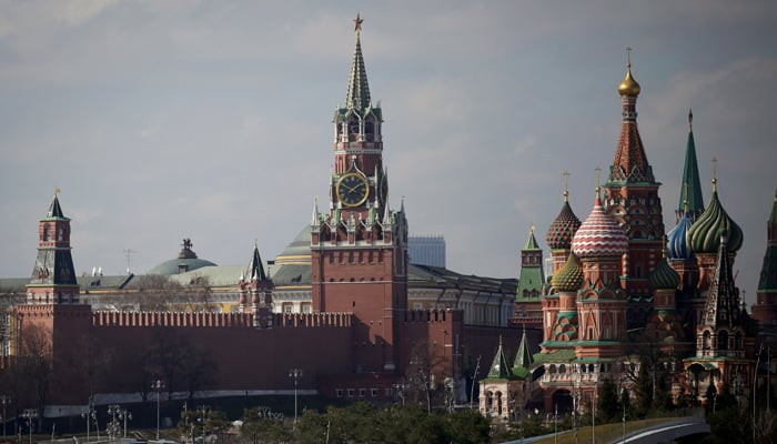 This photograph taken on April 1, 2023, shows a view of the Kremlin with Spasskaya Tower (C) and St. Basils Cathedral (R) in downtown Moscow. — AFP