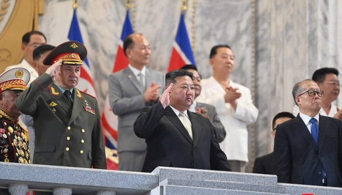 Kim Jong Un (center) oversees the military parade alongside Russian Defence Minister Sergei Shoigu (left) and Chinese Communist Party Politburo member Li Hongzhong held in Pyongyang to mark the 70th anniversary of the Korean War, featuring nuclear-capable weapons on July 28, 2023. — KCNA