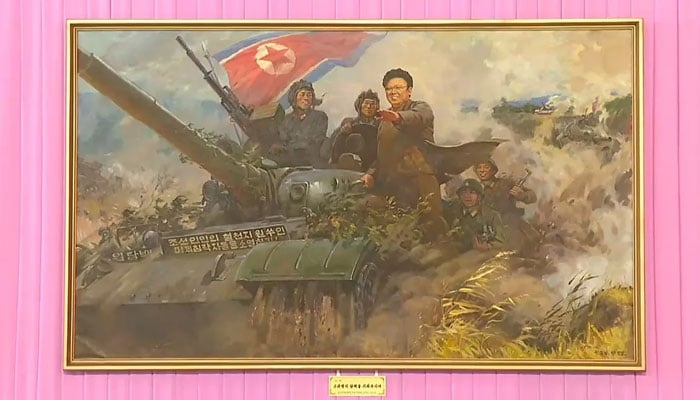 Kim Jong Il depicted riding atop a tank and guiding his troops to victory. — KCNA