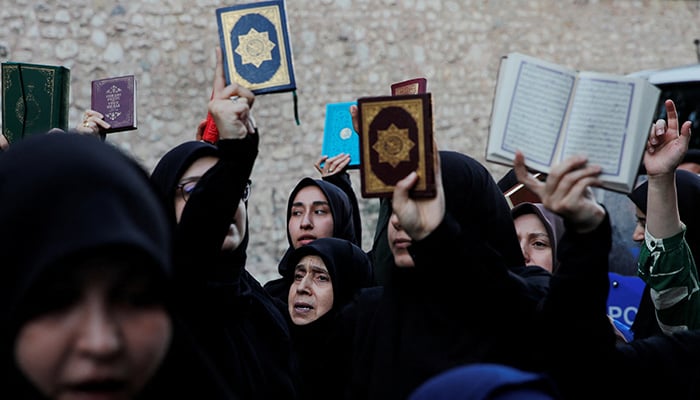 Protesters hold copies of the Holy Quran as they demonstrate outside the Consulate General of Sweden in Istanbul, Turkey, July 30, 2023. — Reuters